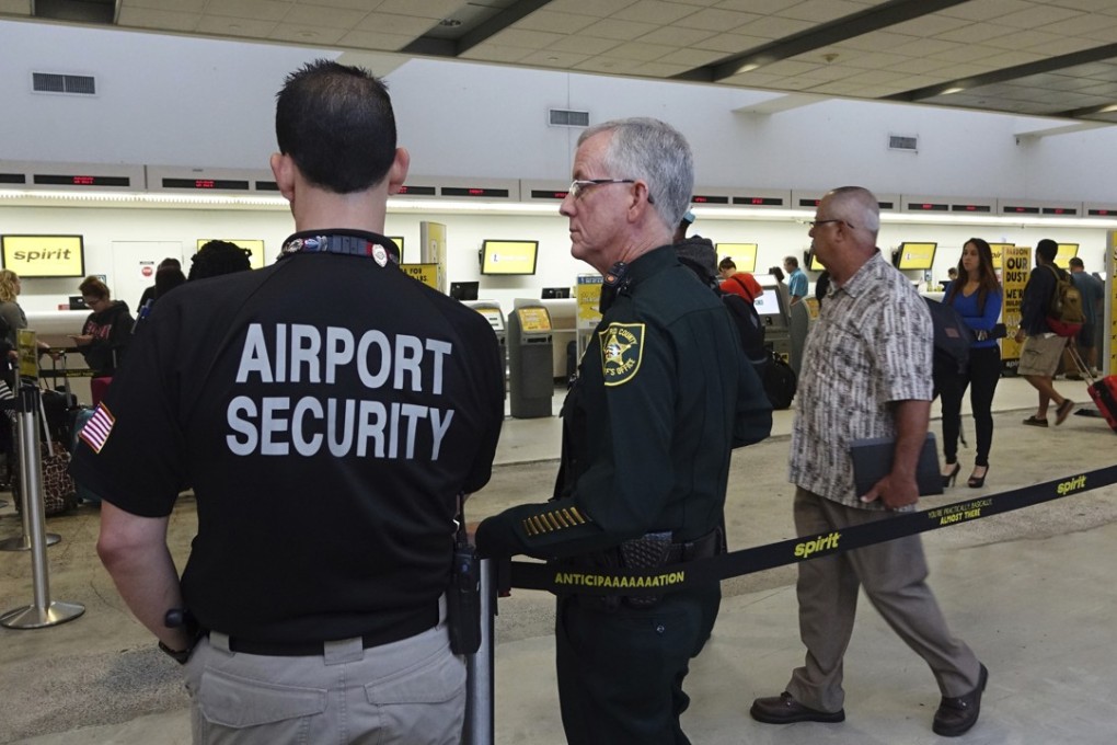 Airport Security and a Broward Sherriff's Deputy keep an eye on the line at Spirit Airlines on Tuesday, May 9, 2017, at the Fort Lauderdale-Hollywood International Airport in Florida where skirmishes involving irate passengers broke out at the airport Monday following the cancellation of multiple Spirit Airlines flights. Photo: South Florida Sun-Sentinel via AP