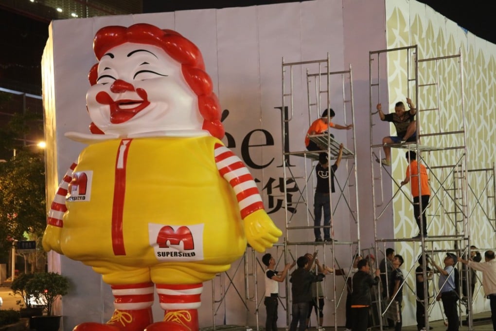 Ron English’s giant MC Supersized figure being removed from outside the Reel Department Store in Shanghai.