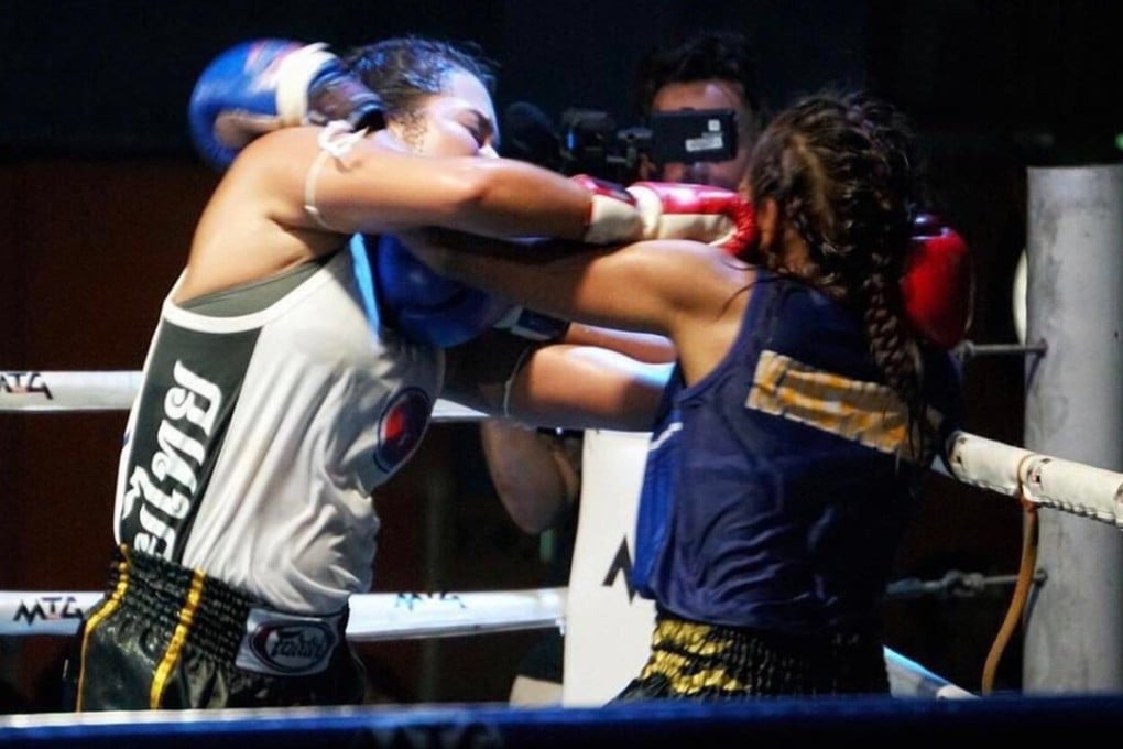 Mia Kang grapples with her opponent Nong B during her debut muay thai victory in Thailand on Sunday. Photo: Facebook (Malcolm Wood)
