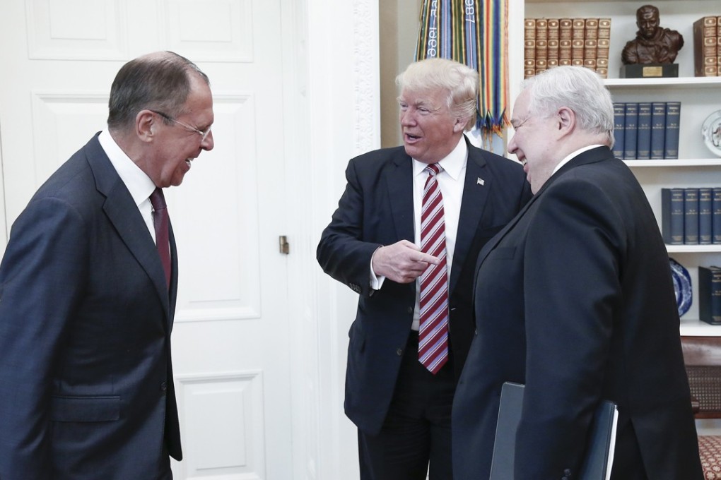 From left, Russia's Foreign Minister Sergei Lavrov, US President Donald Trump, and Russian Ambassador to the United States Sergei Kislyak talk during a meeting in the Oval Office at the White House. Photo: TNS