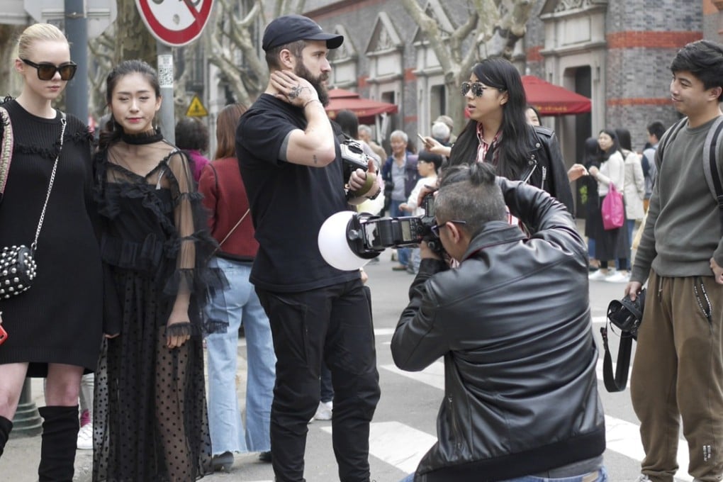A photographer snaps Shanghai Fashion Week guests. Photo: Clay Hales