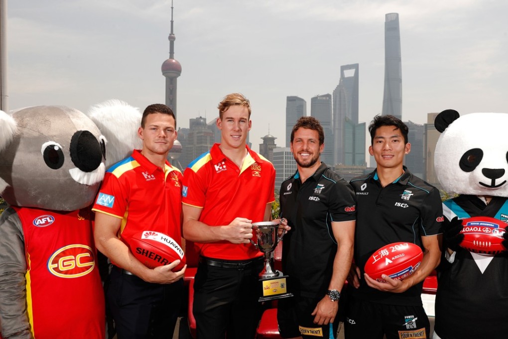 Steven May of the Suns, Tom Lynch of the Suns, Travis Boak of the Power and Chen Shaoliang of the Power pose for a photograph with the 2017 Shanghai Cup during the Port Adelaide Power and Gold Coast Suns joint Captain and Coach press conference at Bar Rouge overlooking The Bund on May 11, 2017 in Shanghai, China. (Photo by Michael Willson/AFL Media)