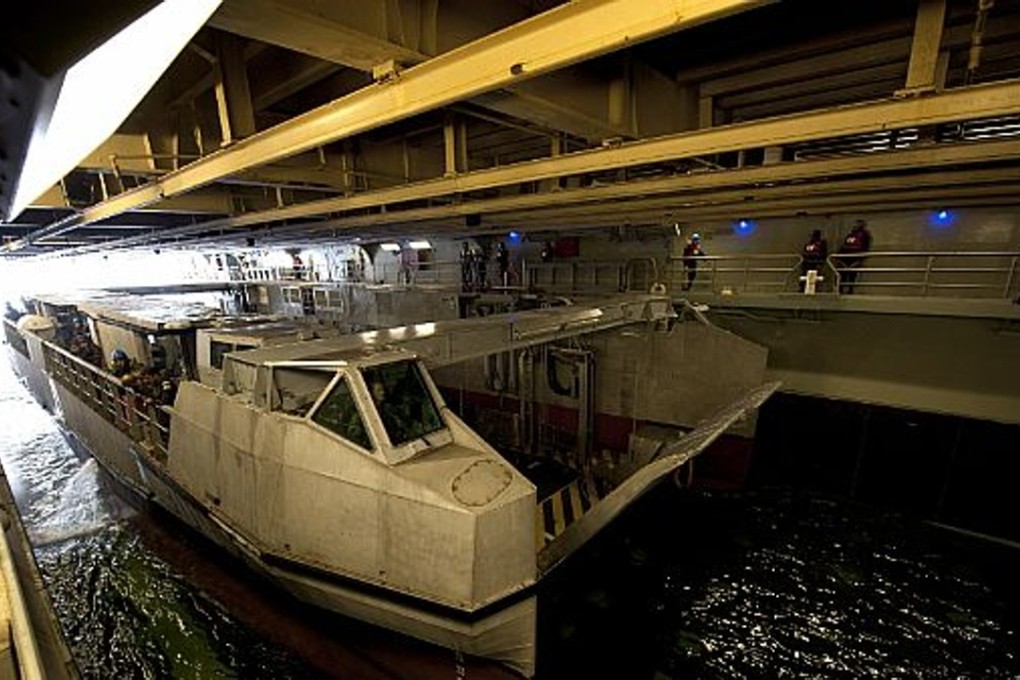 A French landing catamaran (L-CAT) assigned to the French amphibious assault ship FS Mistral (L9013) prepares to pull into the well deck of the amphibious assault ship USS Wasp in 2012. French-led amphibious force, including contingents from Japan, Britain and the United States, postponed their first-ever joint beach attack drills in the Western Pacific on Friday after a landing craft ran aground. File photo: US Navy