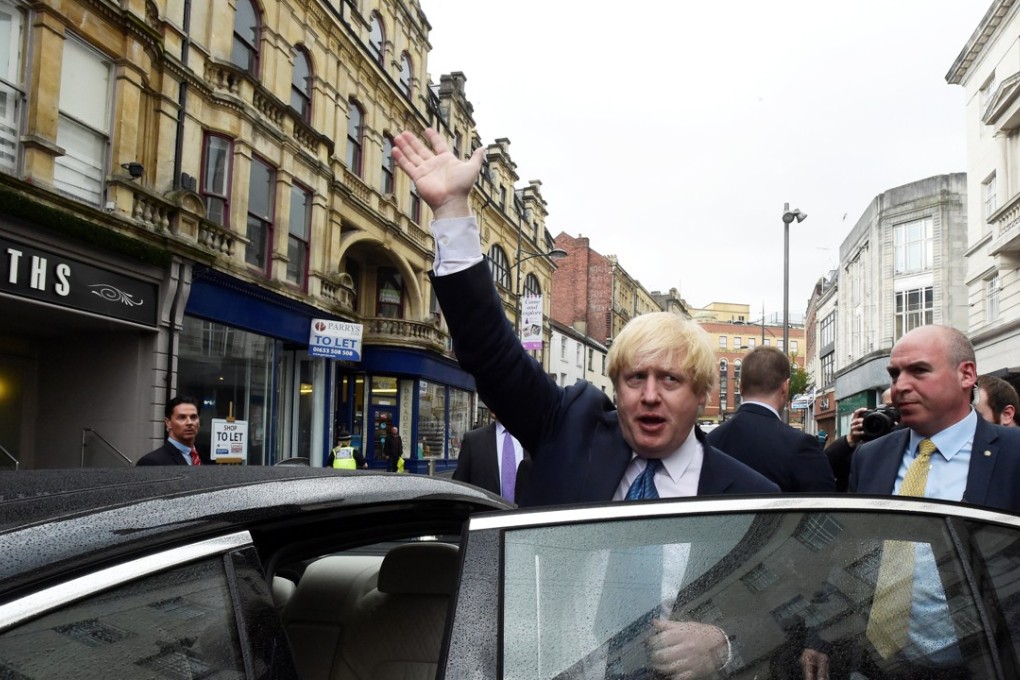 Britain's foreign secretary Boris Johnson waves as he leaves a campaign event in Newport Market, Wales. Photo: Reuters