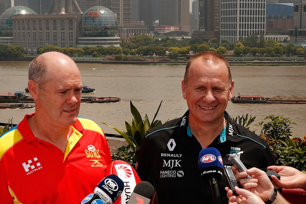Gold Coast coach Rodney Eade and Port Adelaide boss Ken Hinkley address the media in Shanghai with The Bund in the background. Photo: AFL Media