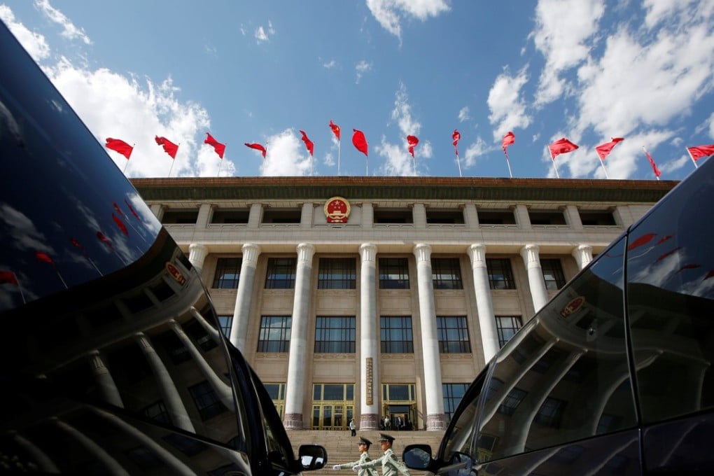 Chinese paramilitary policemen march outside the Great Hall of the People in Beijing on Sunday. Photo: Reuters
