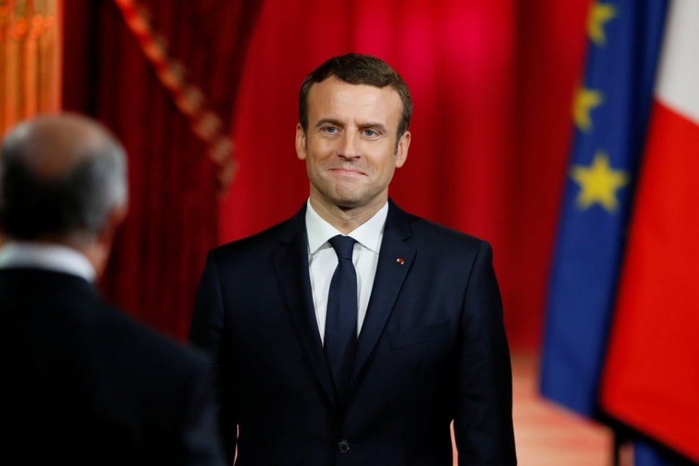 French President Emmanuel Macron listens to Laurent Fabius, head of the Constitutional Council, during his inauguration. Photo: Reuters