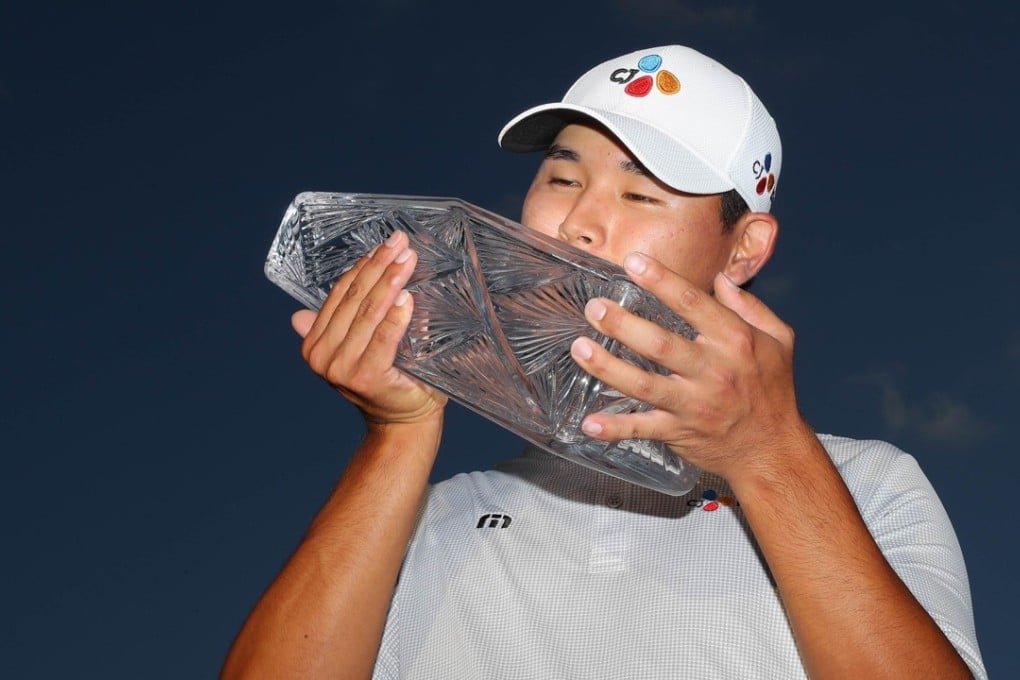 Kim Si-Woo of South Korea celebrates with the winner’s trophy after claiming The Players Championship. Photo: AFP