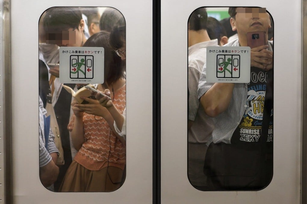 Commuters on a packed train at Ikebukuro Station in Tokyo. Photo: EPA
