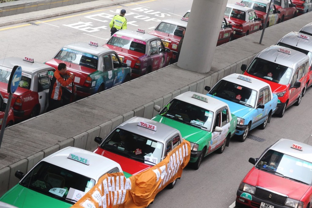 Over 200 taxis staged a demonstration on March 17 near the Central Government Offices to protest against the government proposal which allows an additional 600 premium cars to charge up to 50 per cent more in fares. Photo: Dickson Lee