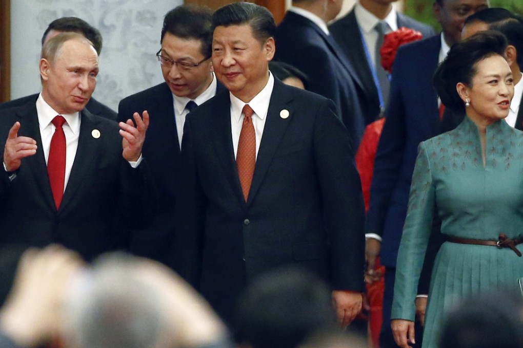 Chinese President Xi Jinping, centre, his wife Peng Liyuan and Russian President Vladimir Putin, left, arrive for a welcome banquet for the Belt and Road Forum at the Great Hall of the People in Beijing, Sunday, May 14, 2017. Photo: AP