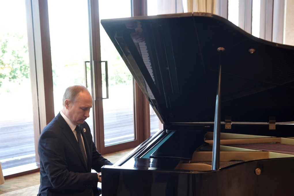 Russian President Vladimir Putin plays the piano before his talks with Chinese President Xi Jinping at the Diaoyutai State Guesthouse in Beijing on Sunday. Photo: Reuters