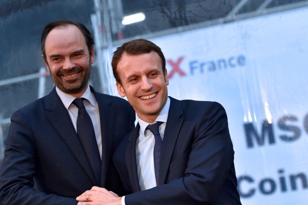 Emmanuel Macron shaking hands with Edouard Philippe. Photo: AFP