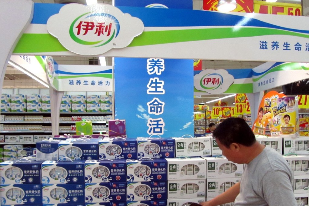 A customer is looking at Yili milk products at a market in Shanghai, China, 19 July 2011. Photo: SCMP