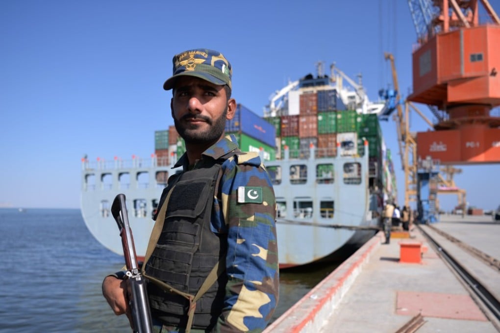 A Pakistani guard beside a ship docked at Gwadar port. Photo: AFP