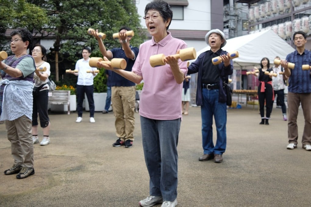 Elderly people exercising outside a temple in Tokyo. Japan is the world’s most aged country with an old-age dependency ratio of 43.3 per cent at the end of 2015. Photo: AFP