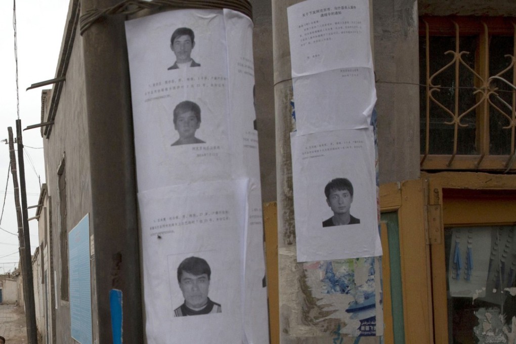 Wanted posters for suspects in terror attacks are seen in this image from 2014 of a street in Aksu, Xinjiang province. Photo: AP