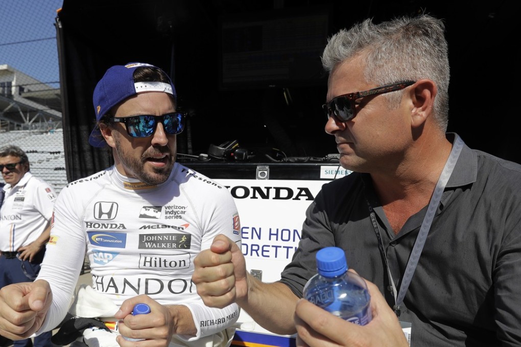 Fernando Alonso talks with Gil de Ferran during a practice session for the Indianapolis 500 IndyCar race. Photo: AP