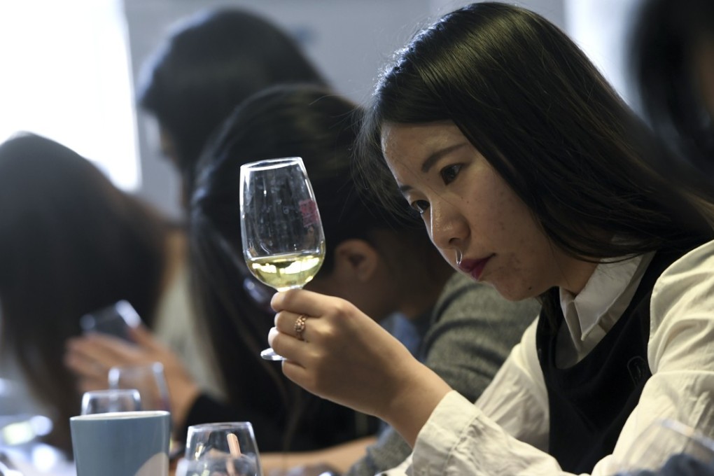 Chinese students taste and study wine. Photo: AFP