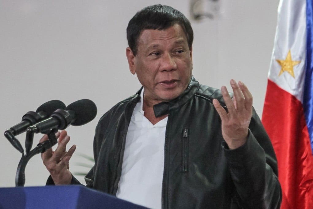 Philippine President Rodrigo Duterte gestures as he speaks shortly after arriving in Davao on May 16, 2017, from a working visit to China. Duterte said on May 16 he was open to jointly exploration with Beijing resources in the disputed South China Sea, following a meeting with Chinese President Xi Jinping. / AFP PHOTO / MANMAN DEJETO