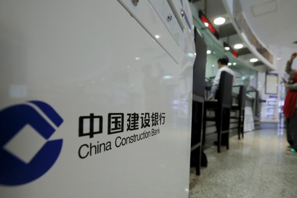 Customers wait in line at a branch of China Construction Bank headquarters in Beijing. Photo: Reuters