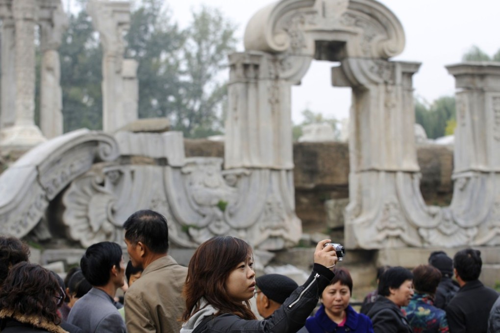 Tourists at the Guanshuifa fountain, part of the ruins of the Old Summer Palace in Beijing. Photo: AFP