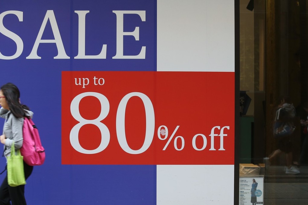 Pedestrian walks past a shop in Causeway Bay, one of Hong Kong’s main shopping districts. Photo: K. Y. Cheng