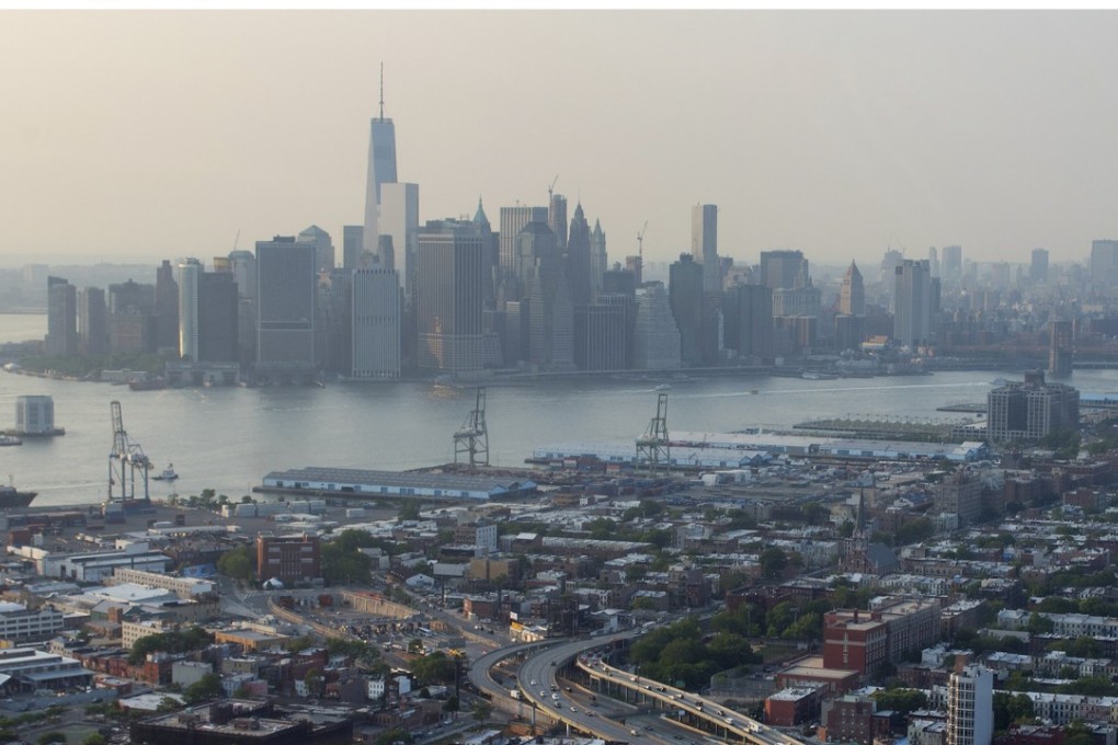 The Manhattan sklyine (top) above the Brooklyn borough of New York. A unit of China’s largest construction and real estate conglomerate plans a US$140 million equity investment in a residential development in the Hudson Square neighbourhood of the island. The US offshoot already has a national portfolio worth in excess of US$1 billion. Photo: Bloomberg