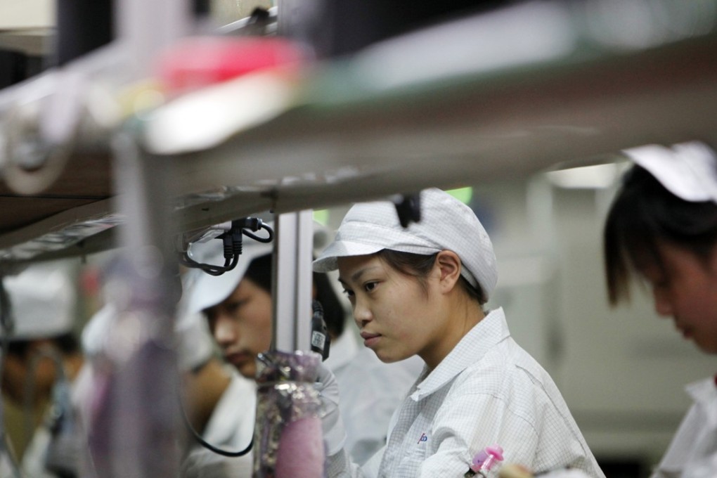 Employees on the assembly line of Hon Hai Group, also called Foxconn, in Shenzhen. The company is the world’s largest electronics contract manufacturer, producing Apple’s iPhones and iPads. Photo: SCMP