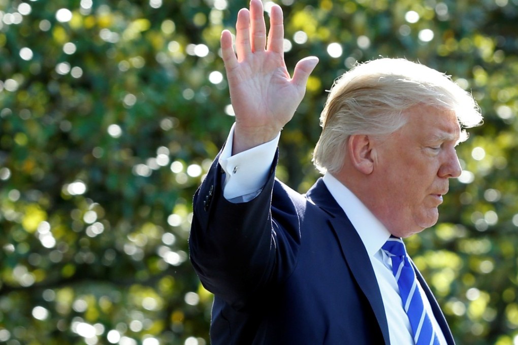 US President Donald Trump waves as he walks on the South Lawn of the White House as a controversy on his dealings with former FBI director James Comey deepened with the US Congress investigating the matter. Photo: Reuters