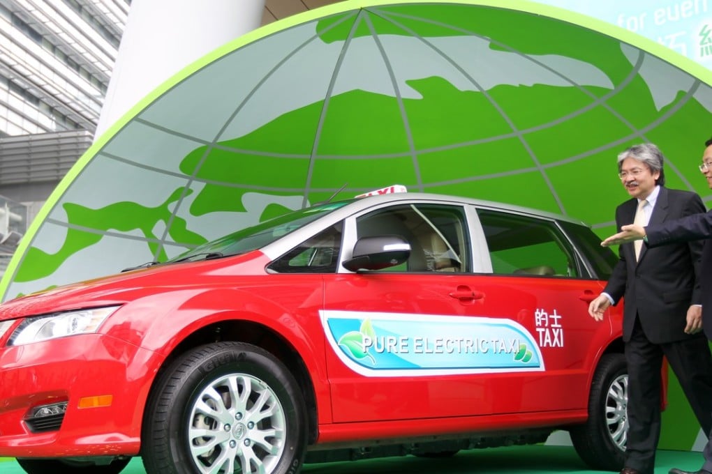 Former Hong Kong finance secretary John Tsang (left) viewing an electric taxi on display in Sha Tin. Photo: K. Y. Cheng
