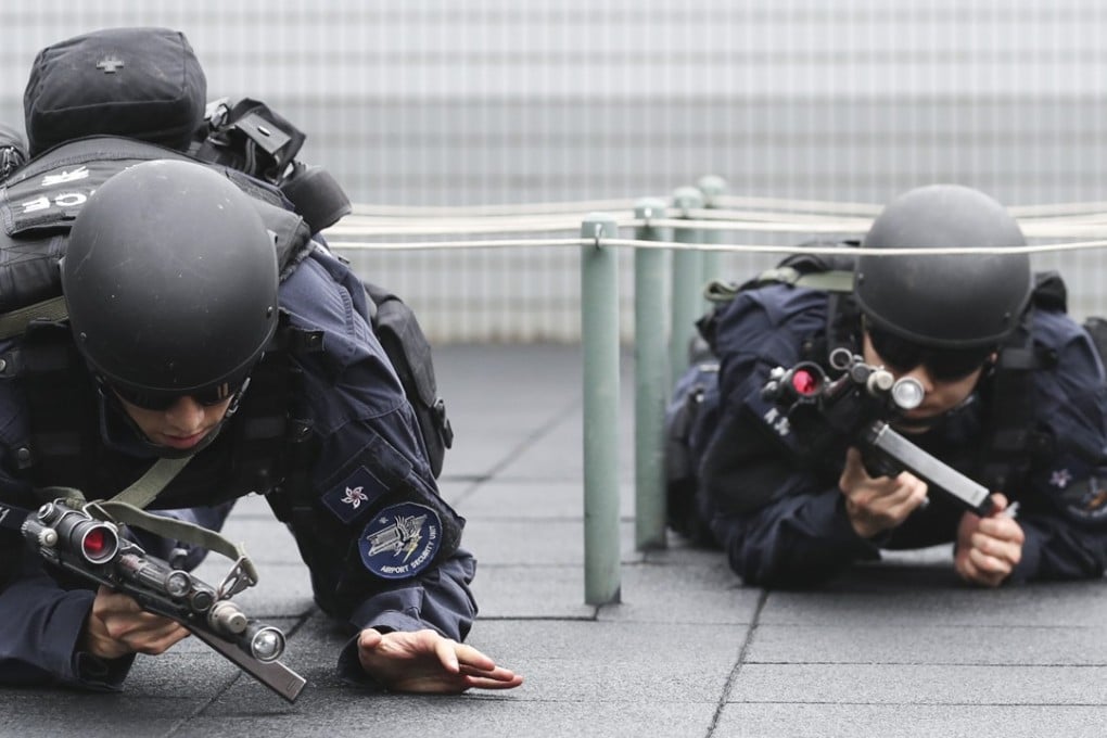 Heavily armed police officers serve as an immediate deterrent at Hong Kong International Airport. Photo: Edward Wong