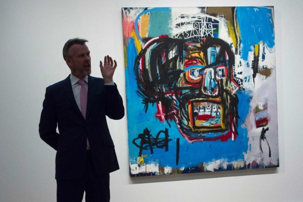 This file photo taken on May 5 shows a Sotheby's official speaking about Untitled, a 1982 painting by Jean-Michel Basquiat that sold for US$110.5 million in New York on Thursday. Photo: AFP