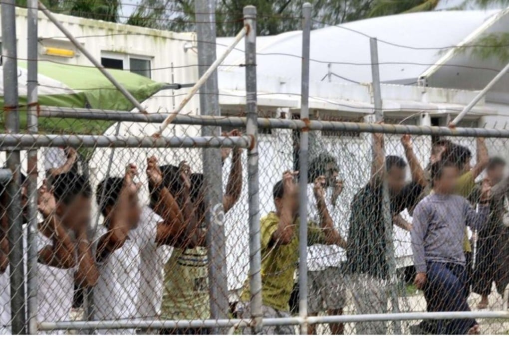 Asylum seekers behind a fence at the Manus Island detention centre, in Papua New Guinea. File photo: EPA