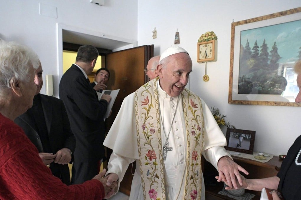 Pope Francis shows up in a home during his visit to Ostia, Rome's neighbourhood, where he met and blessed the homes of some inhabitants. Photo: EPA/Osservatore Romano