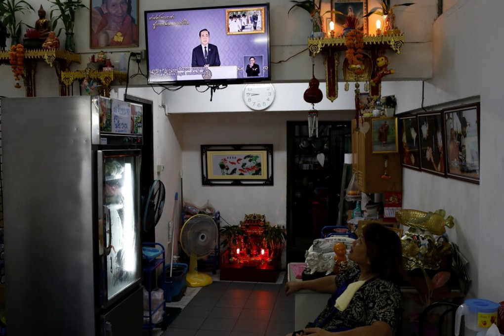A woman watching Thai Prime Minister Prayuth Chan-ocha during his weekly broadcast. Photo: Reuters