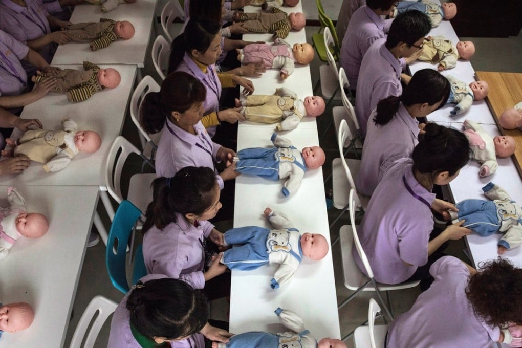 A file picture of women training to be a nannies in Beijing using plastic babies during one class. Photo: Getty Images