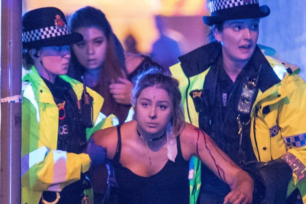 An injured concertgoer is helped by police and emergency responders. Photo: TNS