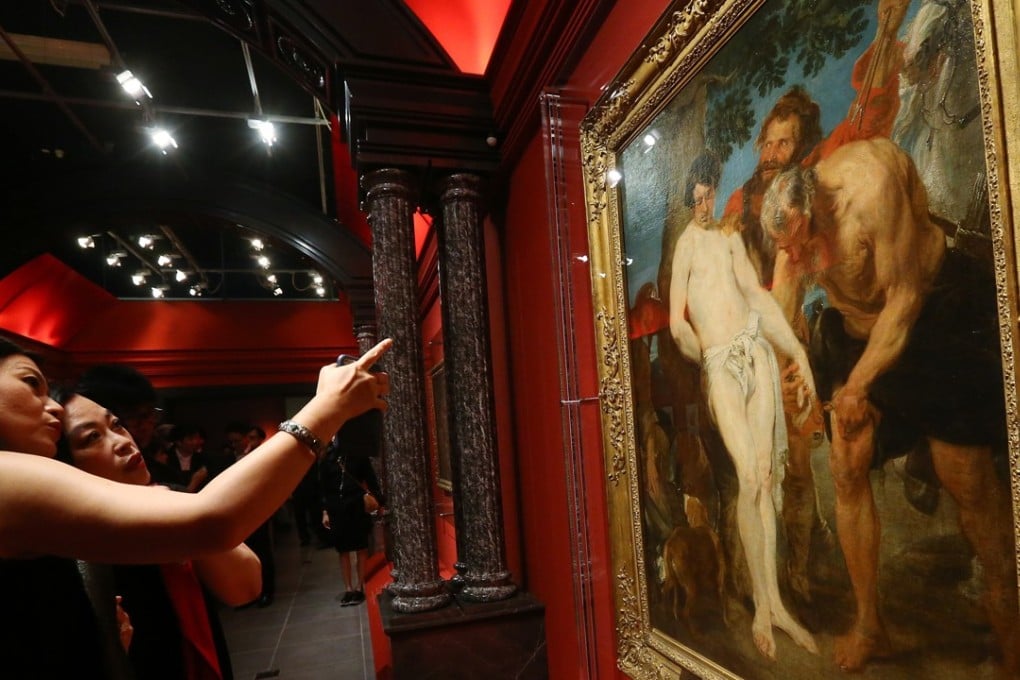 Visitors take in the painting Saint Sebastian Bound for Martyrdom, circa 1617-1619, displayed at the Inventing Le Louvre exhibition at the Hong Kong Heritage Museum. Photo: Dickson Lee