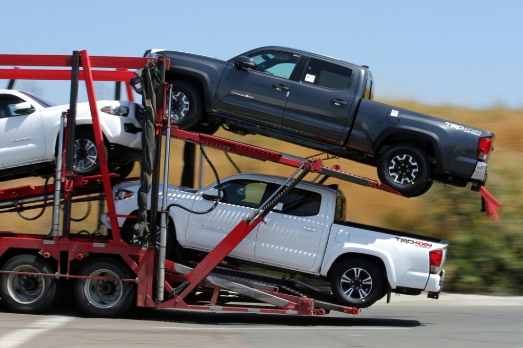 A transporter hauls new Toyota trucks into the United States from Mexico last month after clearing US customs at the border in Otay Mesa, near San Diego, California. Photo: Reuters