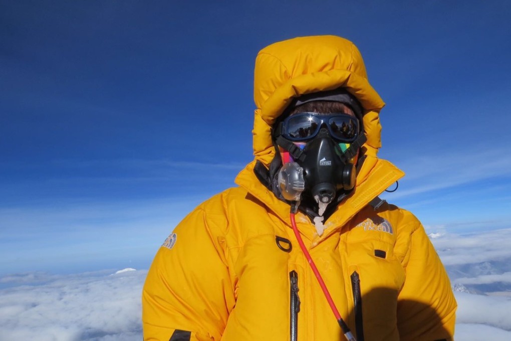 Ada Tsang on the summit with an oxygen mask. Photo: Handout
