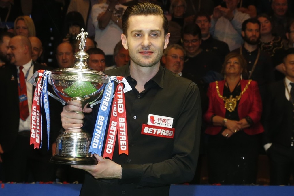 Mark Selby with the world championship trophy after beating John Higgins at The Crucible in Sheffield. Photo: Xinhua