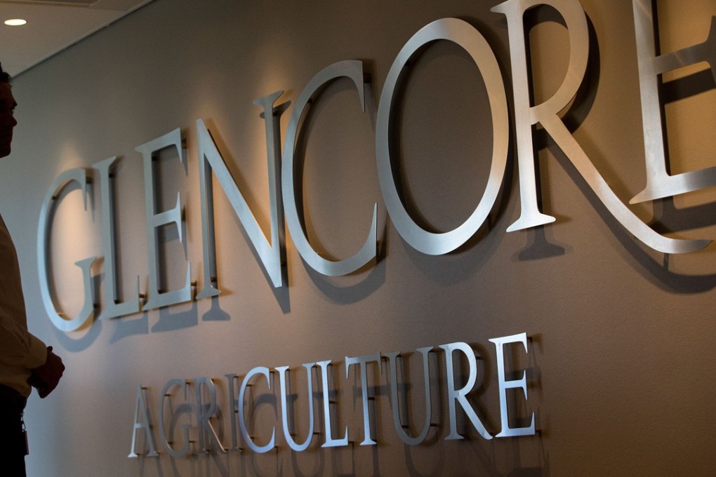 An employee stands by a logo for Glencore Agriculture in Glencore Plc's offices in Rotterdam, Netherlands. The unit is exploring a possible takeover of rivals Bunge. Photo: Bloomberg