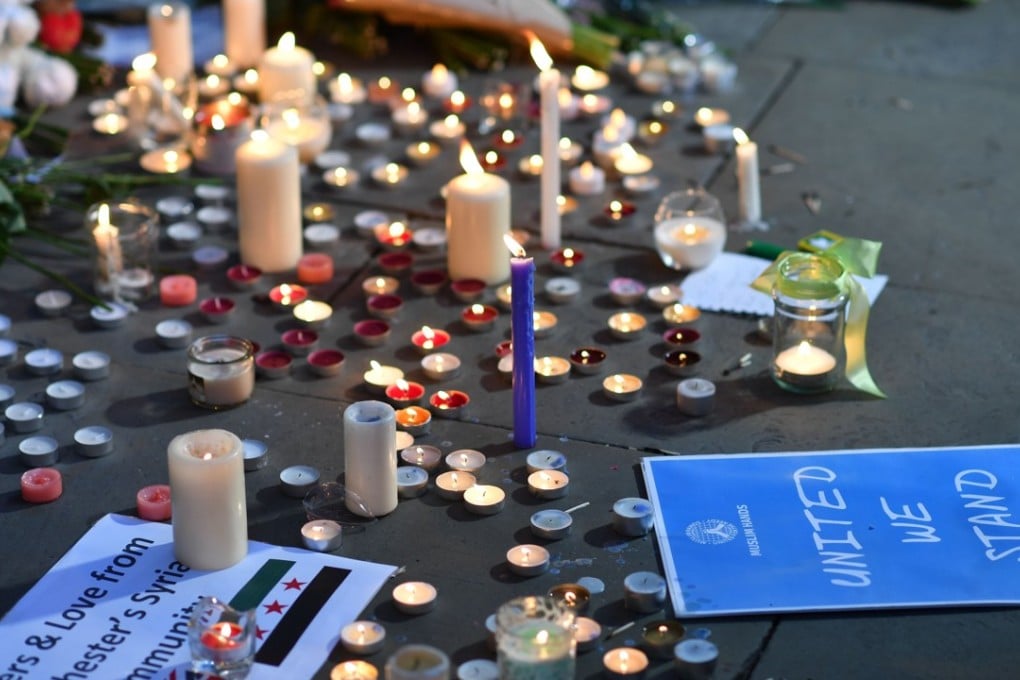 Messages and tributes at a shrine for the victims of the previous day’s terror attack at a music concert, in Manchester’s Albert Square on May 23. Photo: AFP