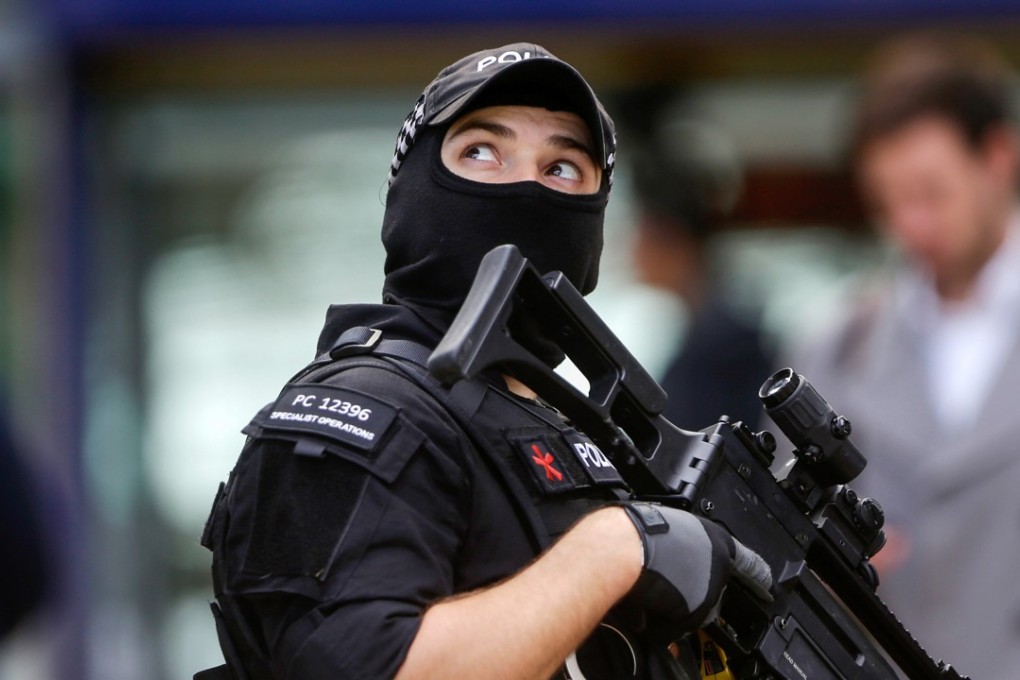 An armed police officer at Manchester Piccadilly railway station in Manchester. Photo: Bloomberg