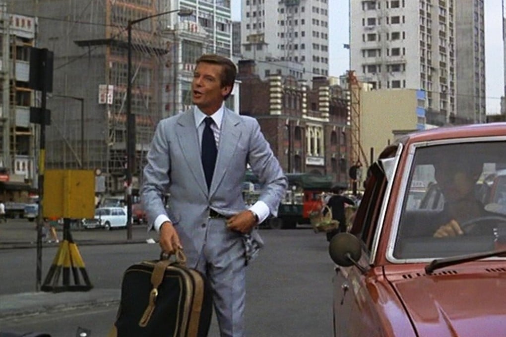 Roger Moore as 007 in a Hong Kong Island street scene in Man with the Golden Gun. Western Market in Sheung Wan is in the background.