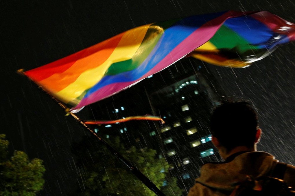 A supporter waves a rainbow flag during a rally after Taiwan’s constitutional court ruled that same-sex couples have the right to legally marry, the first such ruling in Asia, in Taipei on Wednesday. Photo: Reuters