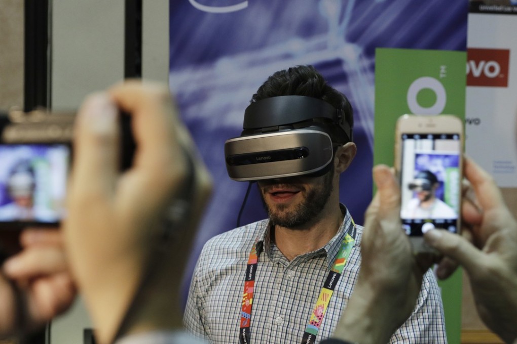 Lenovo swung back to a profit in the financial year to March in what the company acknowledges is a transformational period. A prototype virtual-reality headset is displayed at the Lenovo booth during CES unveiled on in January. Photo: AP