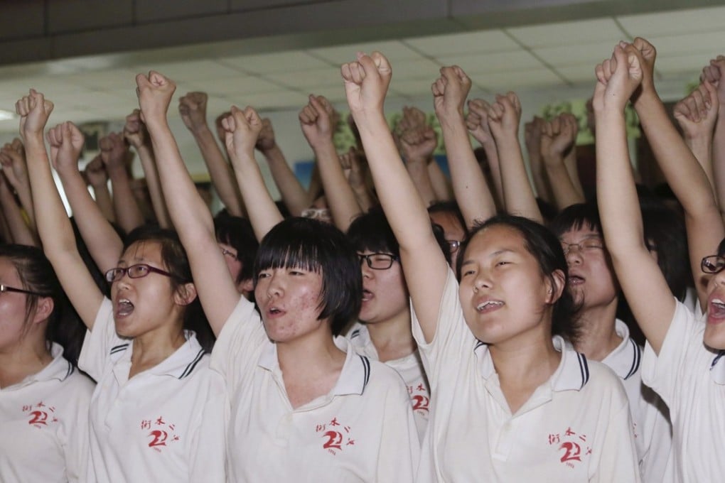 Hengshui No 2 High School pupils in Hengshui, Hebei, cheer during a morale-building event ahead of the university entrance examination in June 2014. Photo: Reuters