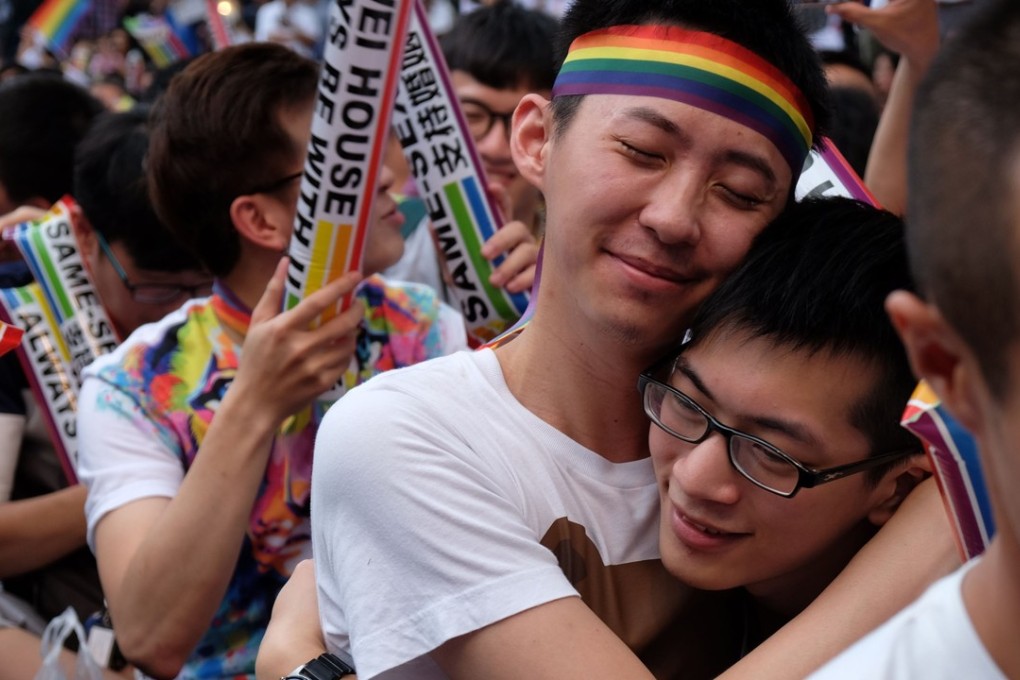 Activists celebrate outside a Taiwan court after its decision to allow same-sex marriage. Photo: AFP